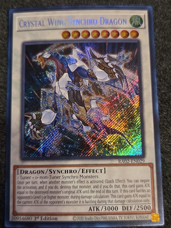 Yugioh! – Crystal Wing Synchro Dragon RA02-EN029 -Secret Ra – 25’TH ANN. – NM/M